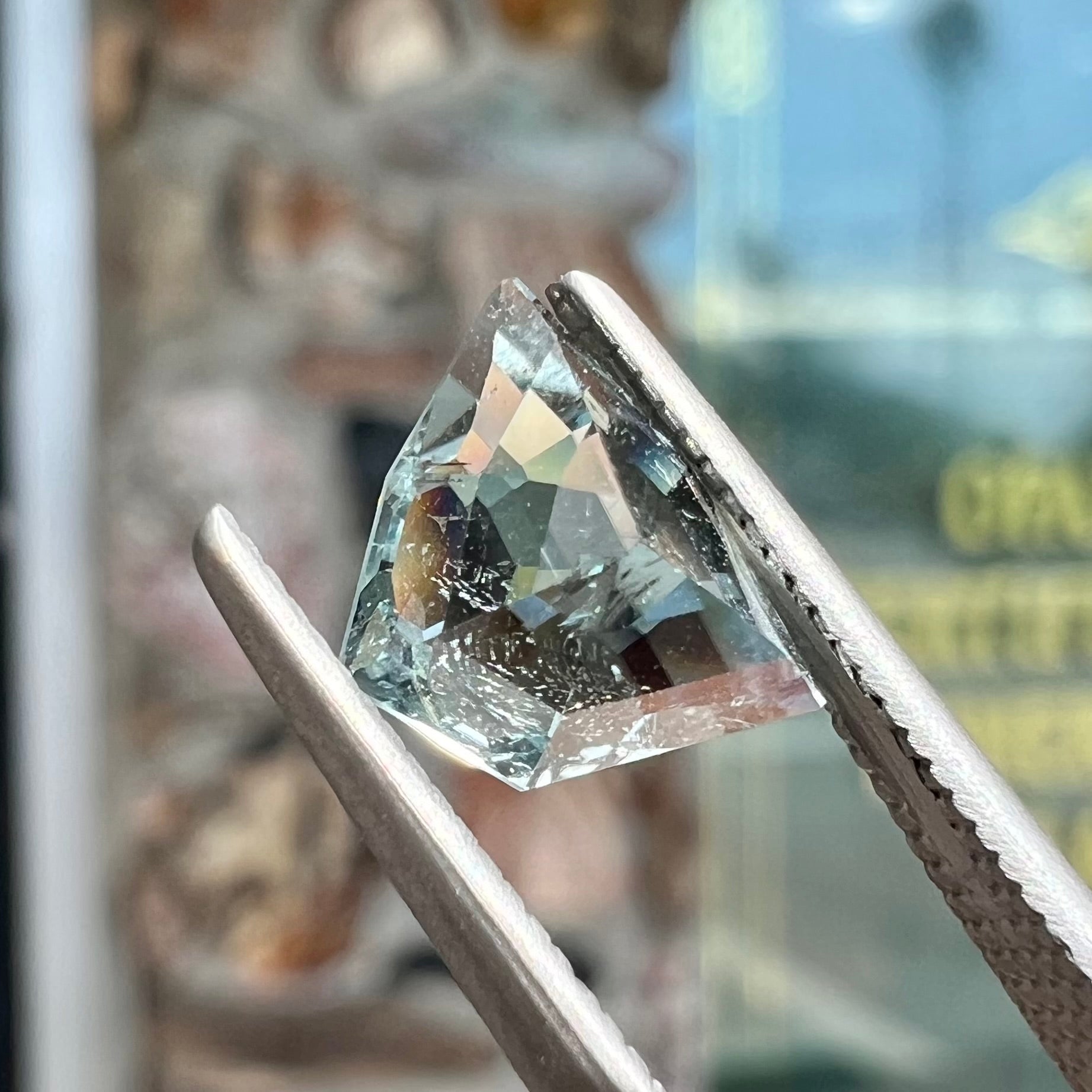 A loose, freeform shield cut tourmaline gemstone.  The stone is a steel blue color.