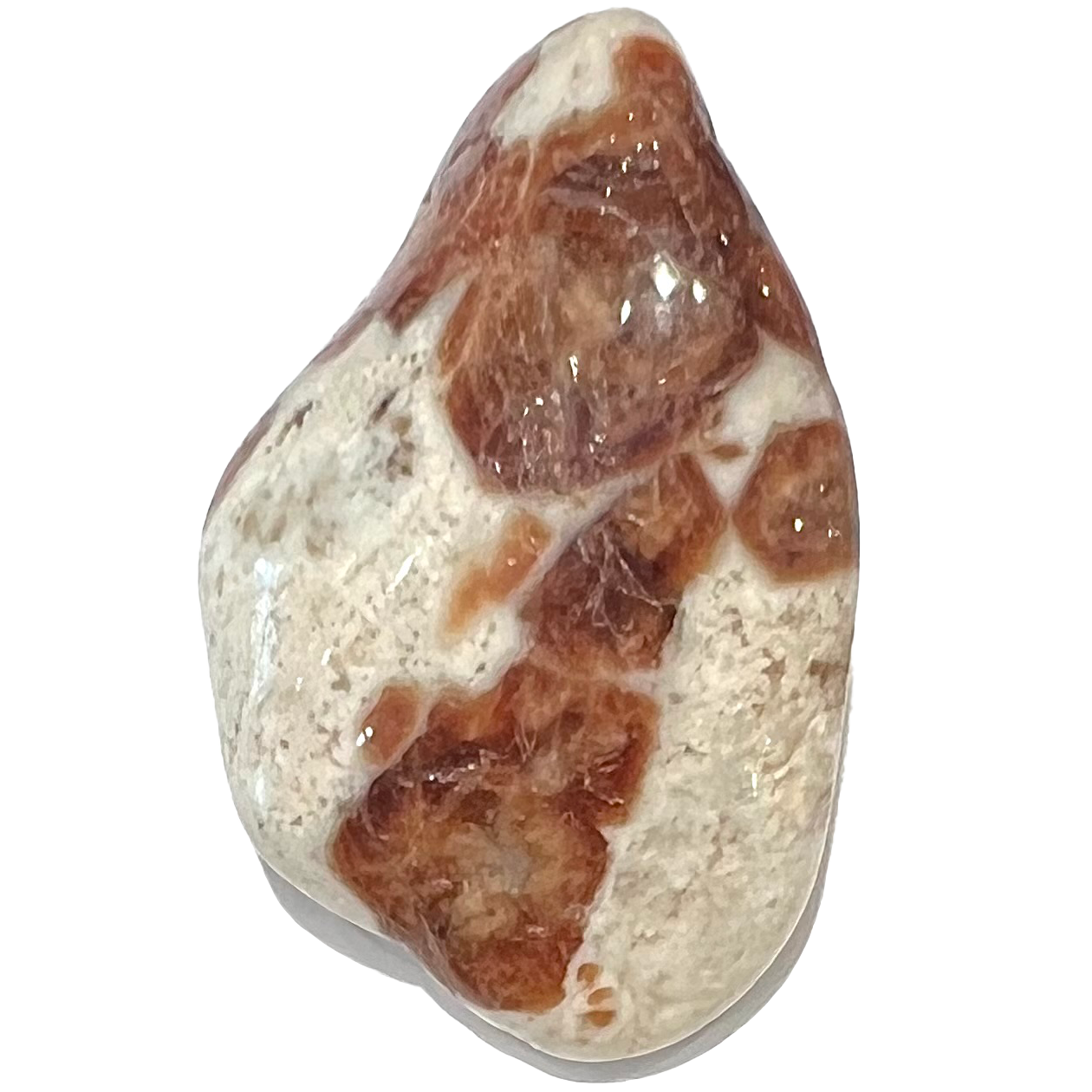 A tumbled white piece of limestone with orange garnet crystal inclusions.