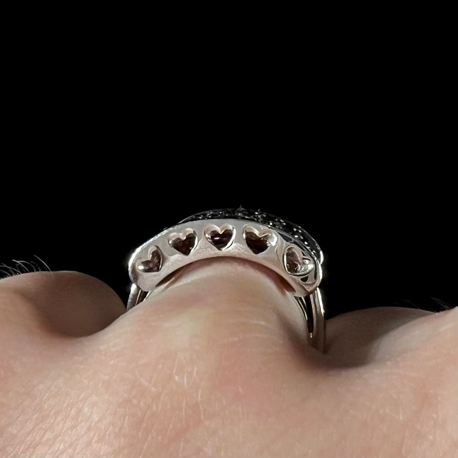 A ladies' bow-shaped designer ring pave set with purple rhodolite garnets and black spinel accents.