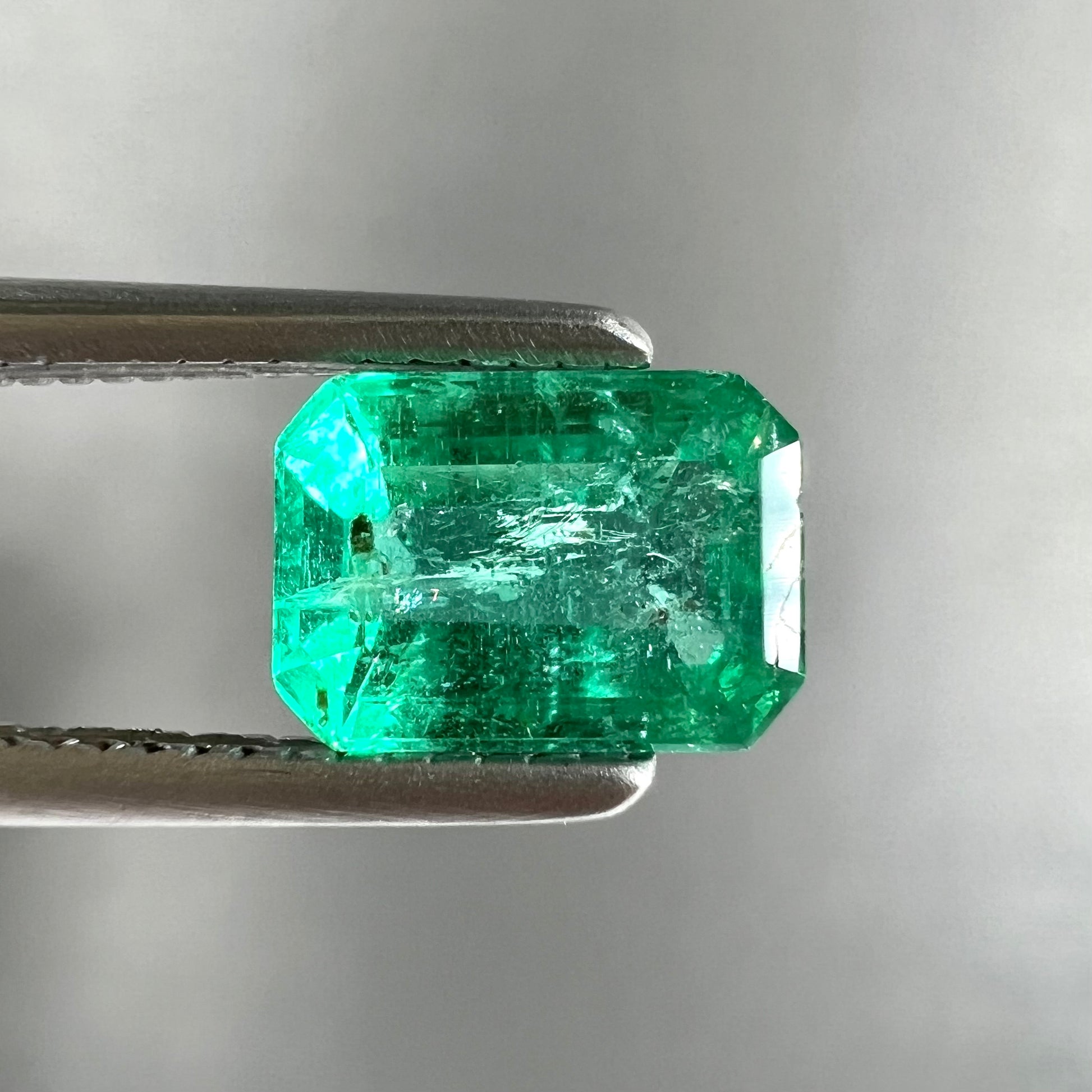 A loose, natural emerald gemstone.  The stone is emerald cut.