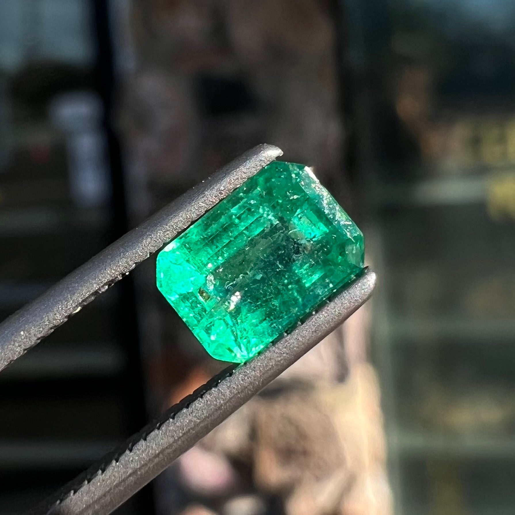 A loose, natural emerald gemstone.  The stone is emerald cut.