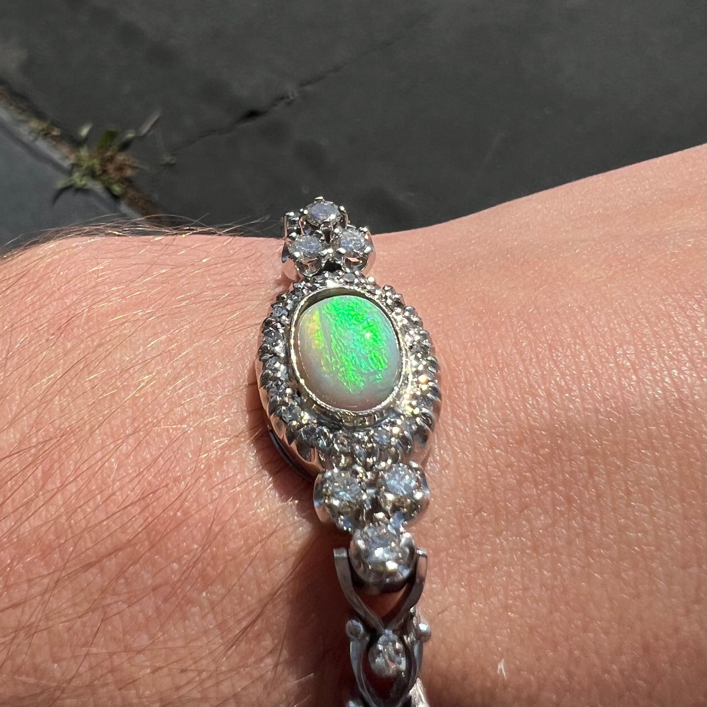 A ladies' vintage, 1930's natural opal bracelet set with accent diamonds in white gold.