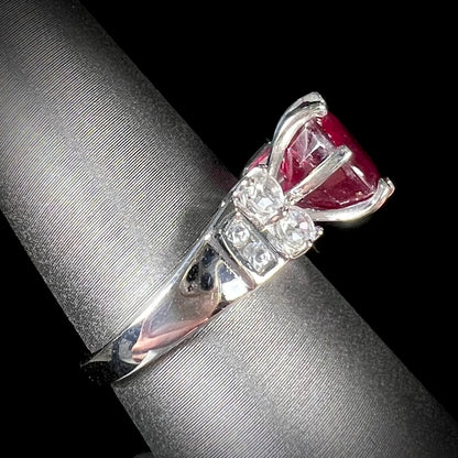 A ladies' sterling silver natural ruby and white zircon ring.  The real ruby is glass filled.