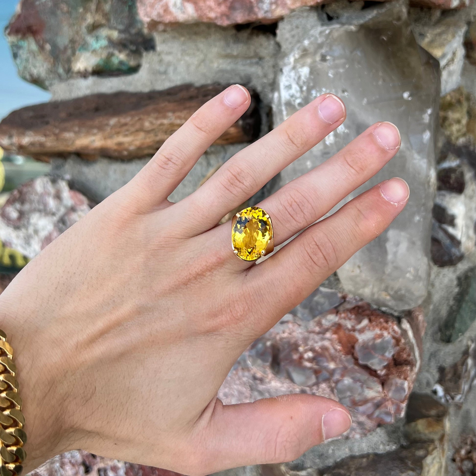 An 18 karat yellow gold solitaire cocktail ring set with a faceted oval cut golden beryl gemstone.