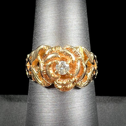 A ladies' yellow gold rose style ring set with a natural 0.10ct diamond.