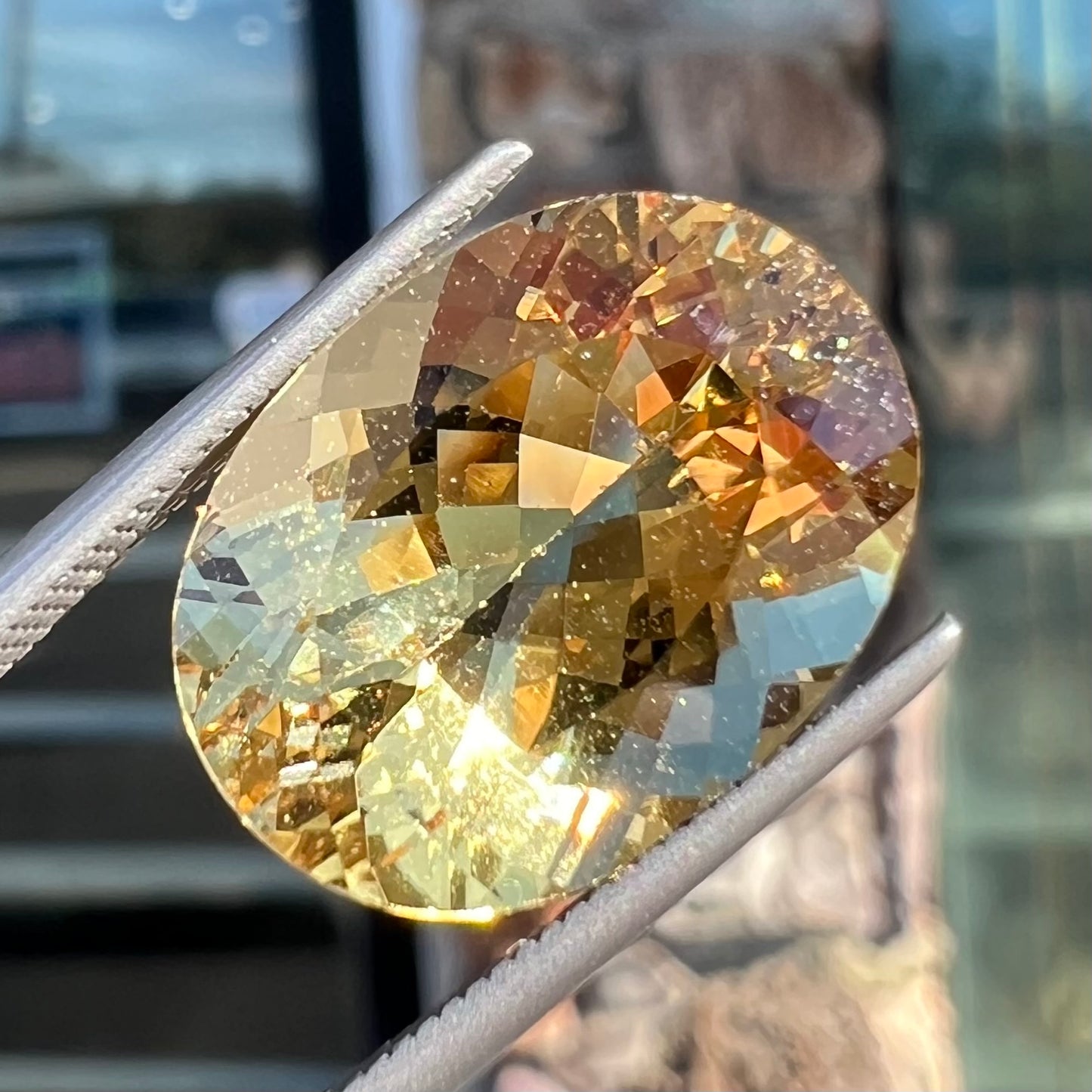 A faceted, oval cut golden beryl gemstone.