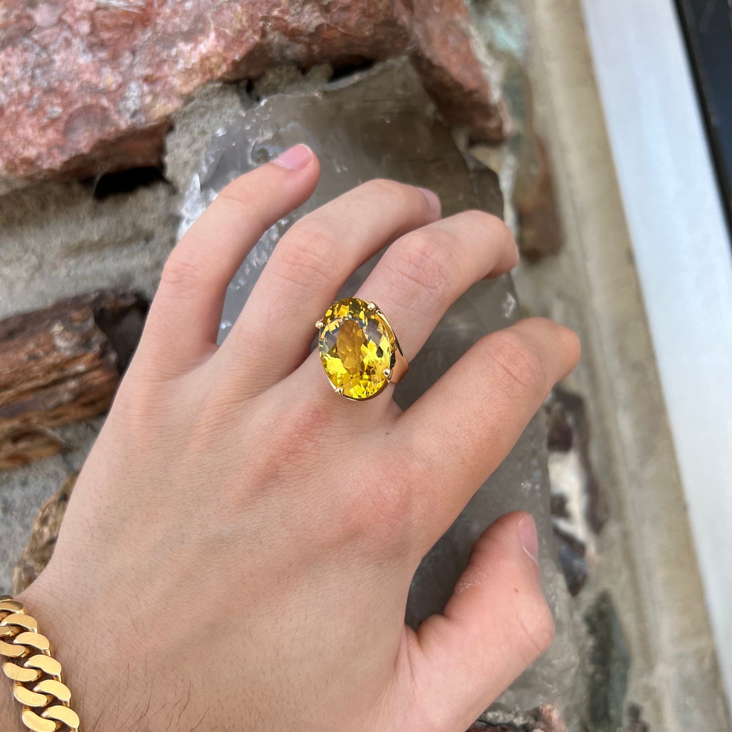 An 18 karat yellow gold solitaire cocktail ring set with a faceted oval cut golden beryl gemstone.