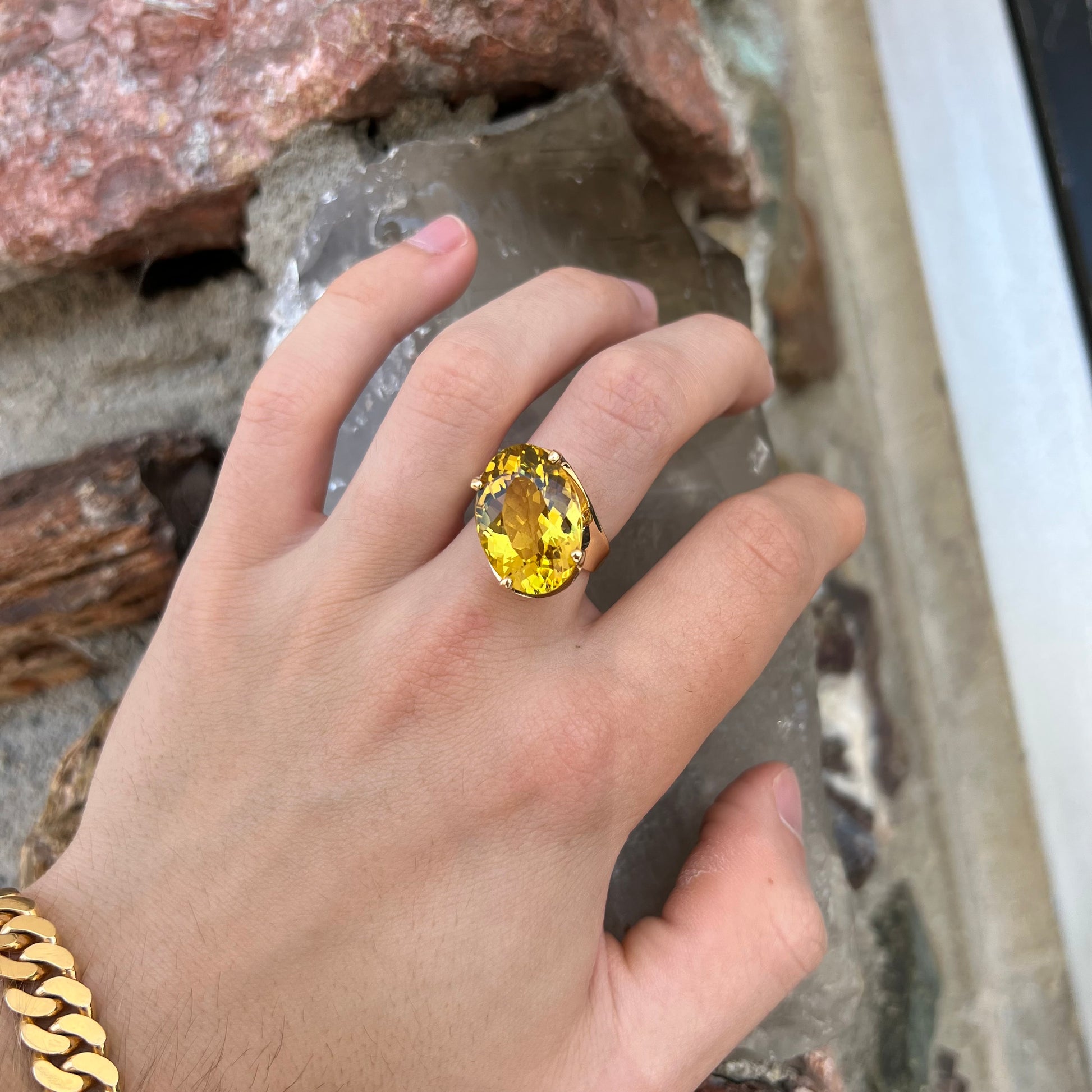 An 18 karat yellow gold solitaire cocktail ring set with a faceted oval cut golden beryl gemstone.