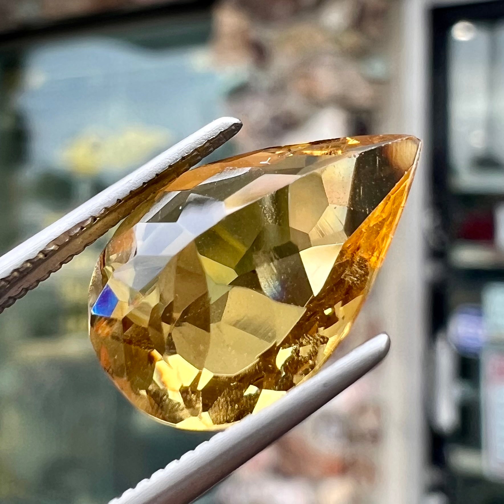 A loose, pear shaped golden beryl gemstone.