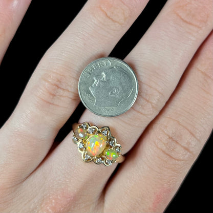 A three-stone gold ring set with Ethiopian fire opals and diamond accents.