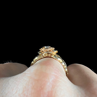 A ladies' yellow gold rose style ring set with a natural 0.10ct diamond.