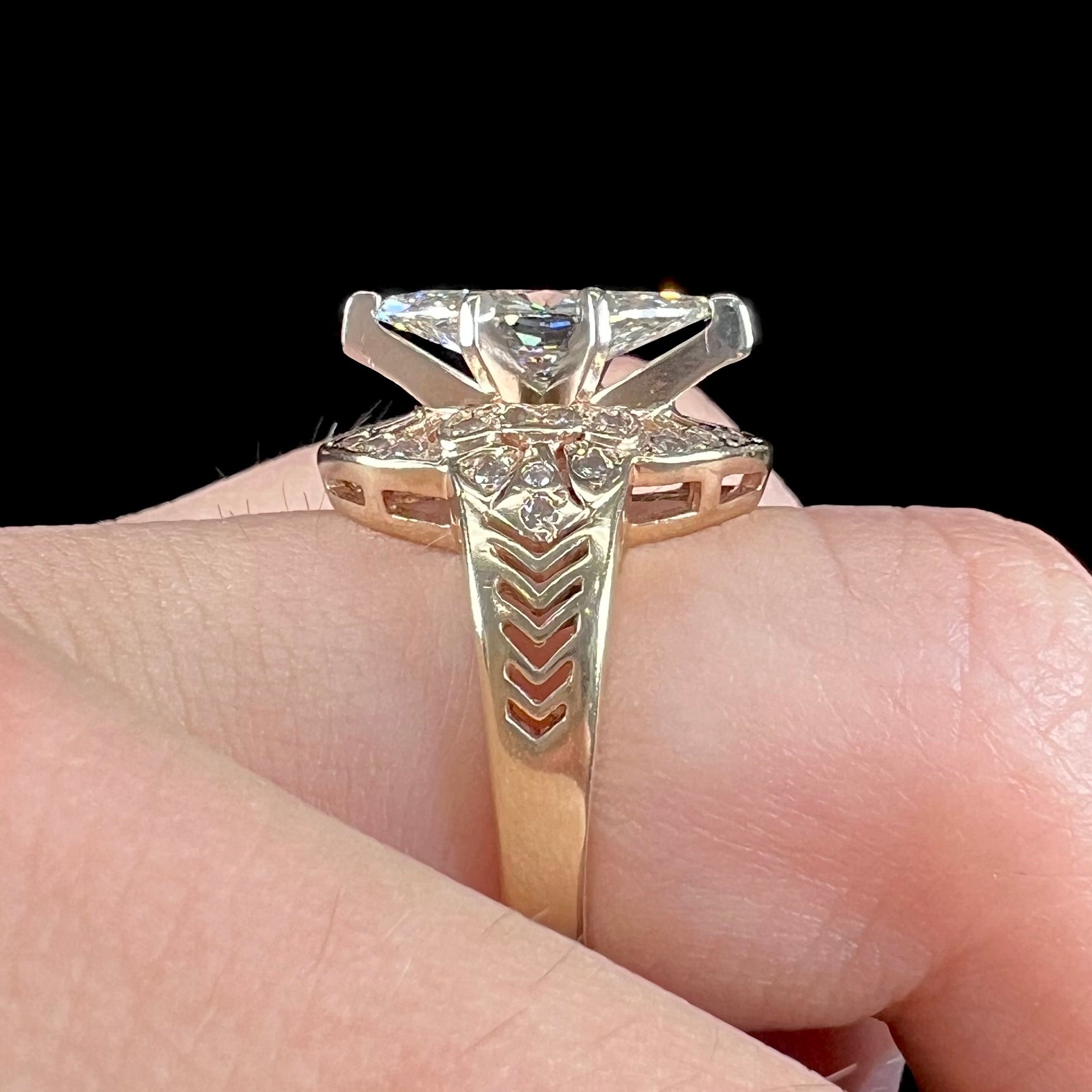 A ladies' yellow gold engagement ring set with a 1.54ct marquise cut natural diamond with round diamond accents.