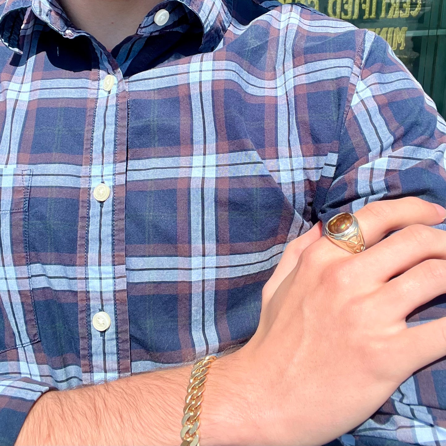A men's solid yellow gold ring set with a Mexican fire agate stone.  The fire agate has a puple bull's eye pattern.