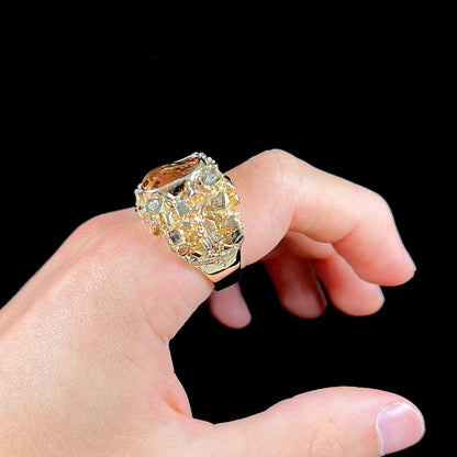 A men's heavy, yellow gold, nugget-style ring bezel set with a Mexican fire agate stone and diamonds.