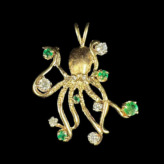 A yellow gold octopus pendant set with round cut emeralds and diamonds in the tentacles.
