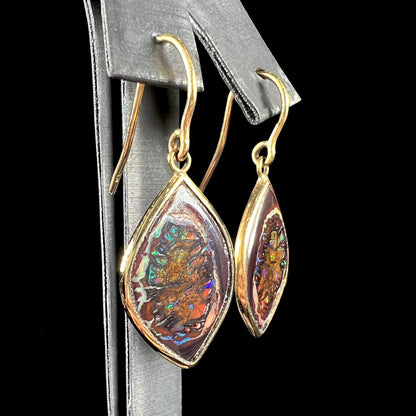 A pair of yellow gold dangle earrings bezel set with natural boulder opals from Koroit, Australia.