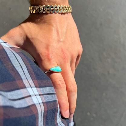A ladies yellow gold solitaire ring bezel set with a natural opalized seashell from Coober Pedy, Australia.