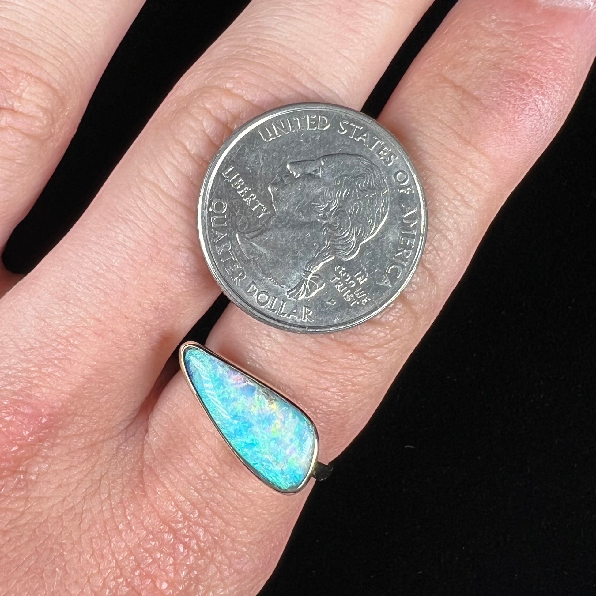 A ladies yellow gold solitaire ring bezel set with a natural opalized seashell from Coober Pedy, Australia.