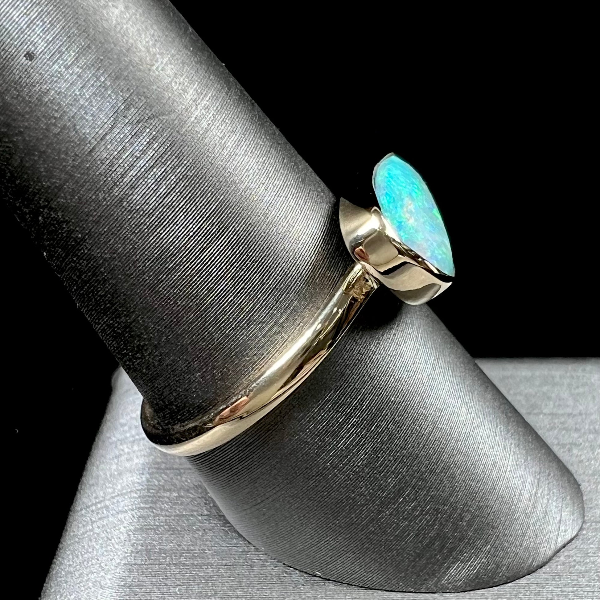 A ladies yellow gold solitaire ring bezel set with a natural opalized seashell from Coober Pedy, Australia.