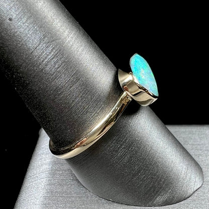 A ladies yellow gold solitaire ring bezel set with a natural opalized seashell from Coober Pedy, Australia.