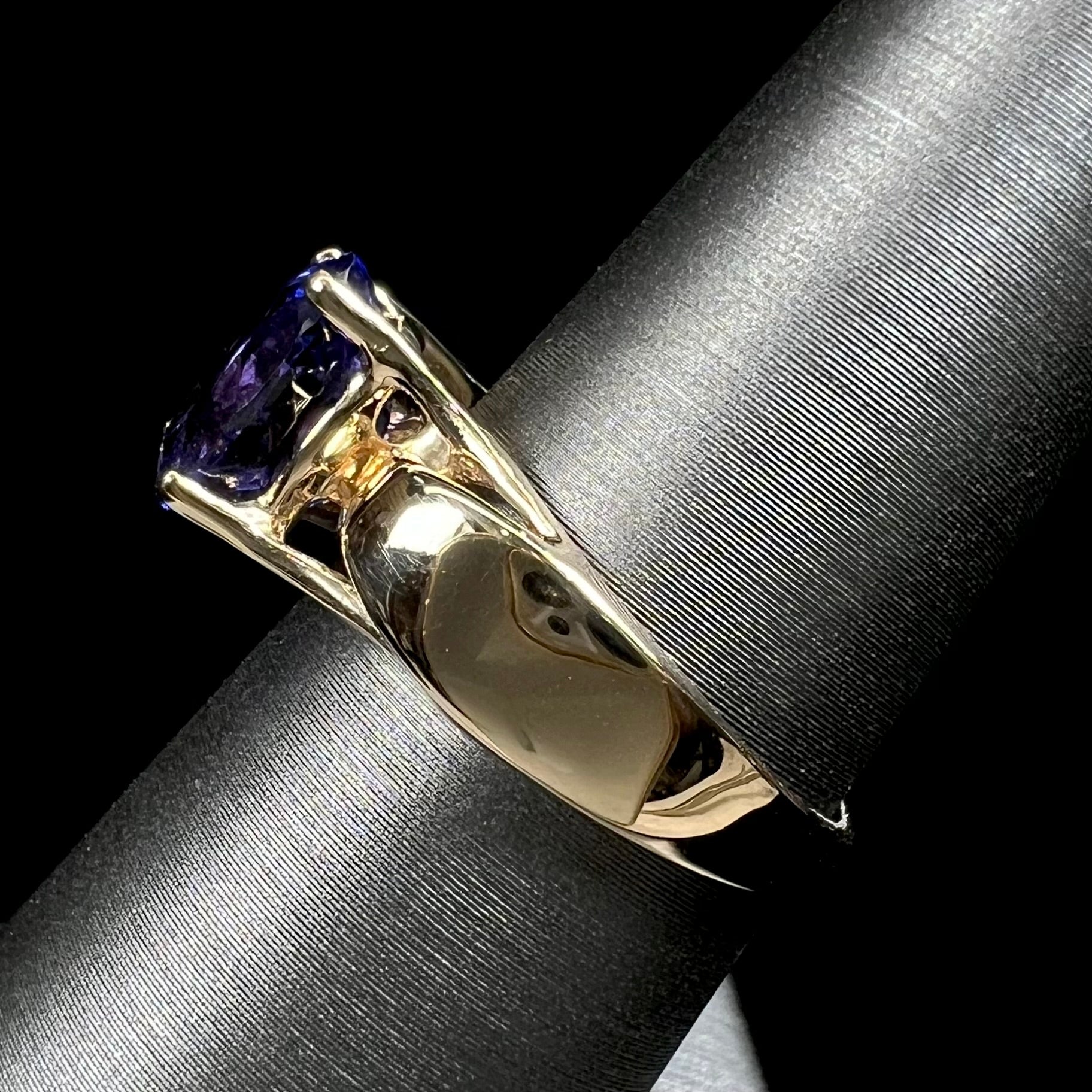 A ladies' oval cut tanzanite solitaire ring set in yellow gold.