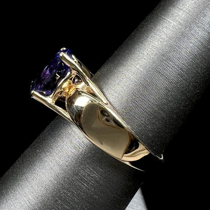 A ladies' oval cut tanzanite solitaire ring set in yellow gold.