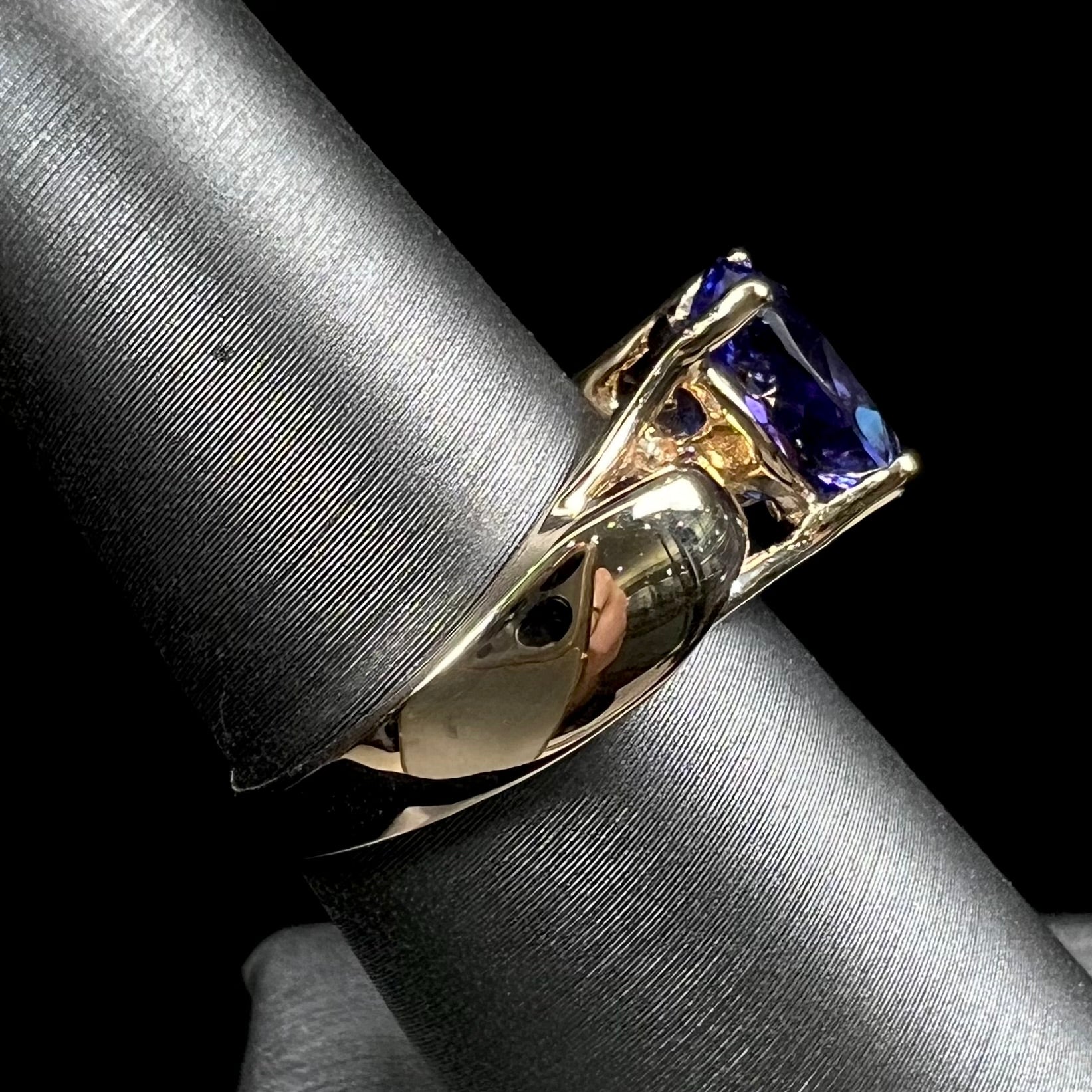 A ladies' oval cut tanzanite solitaire ring set in yellow gold.