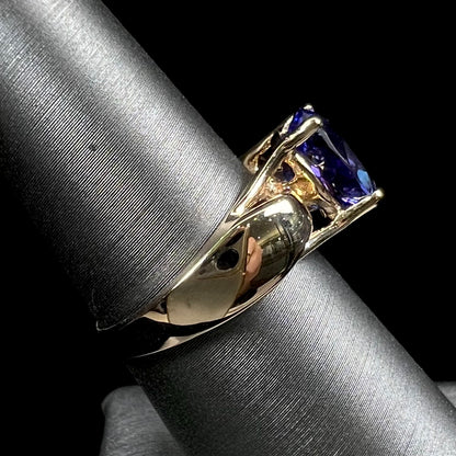 A ladies' oval cut tanzanite solitaire ring set in yellow gold.