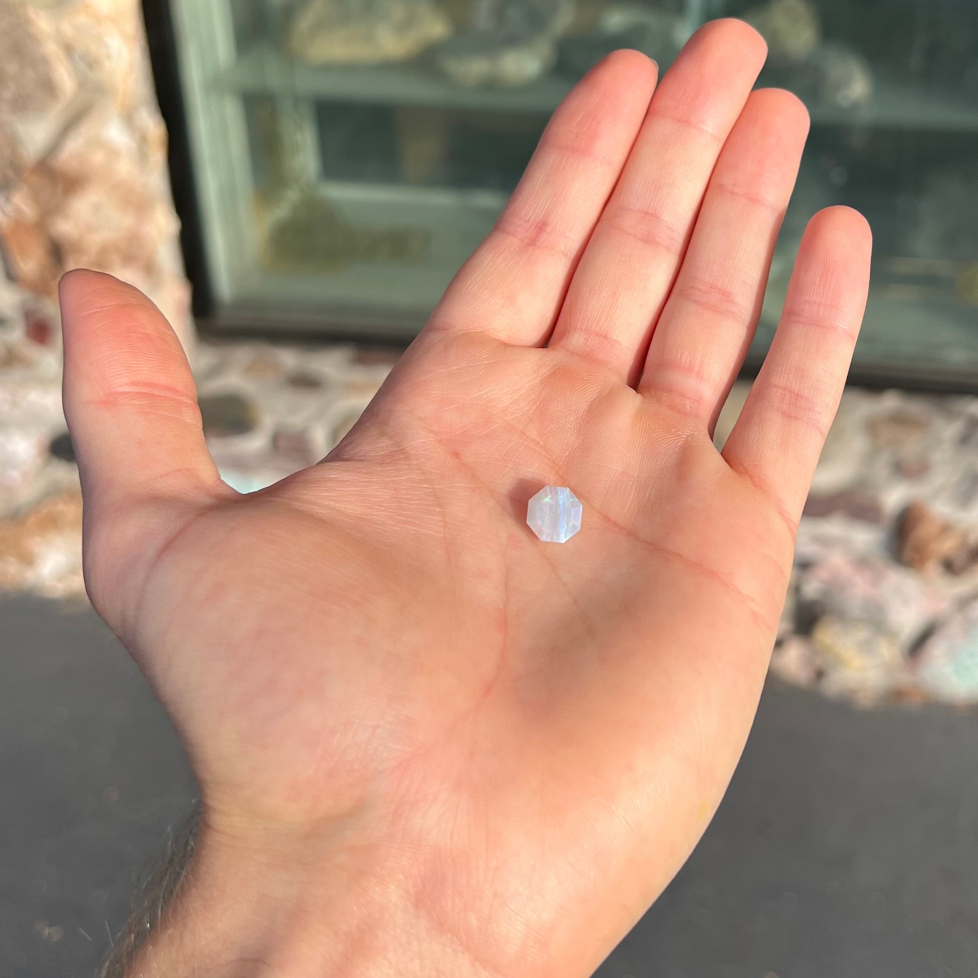 A loose, faceted octagon gray base crystal opal from Lightning Ridge, Australia.