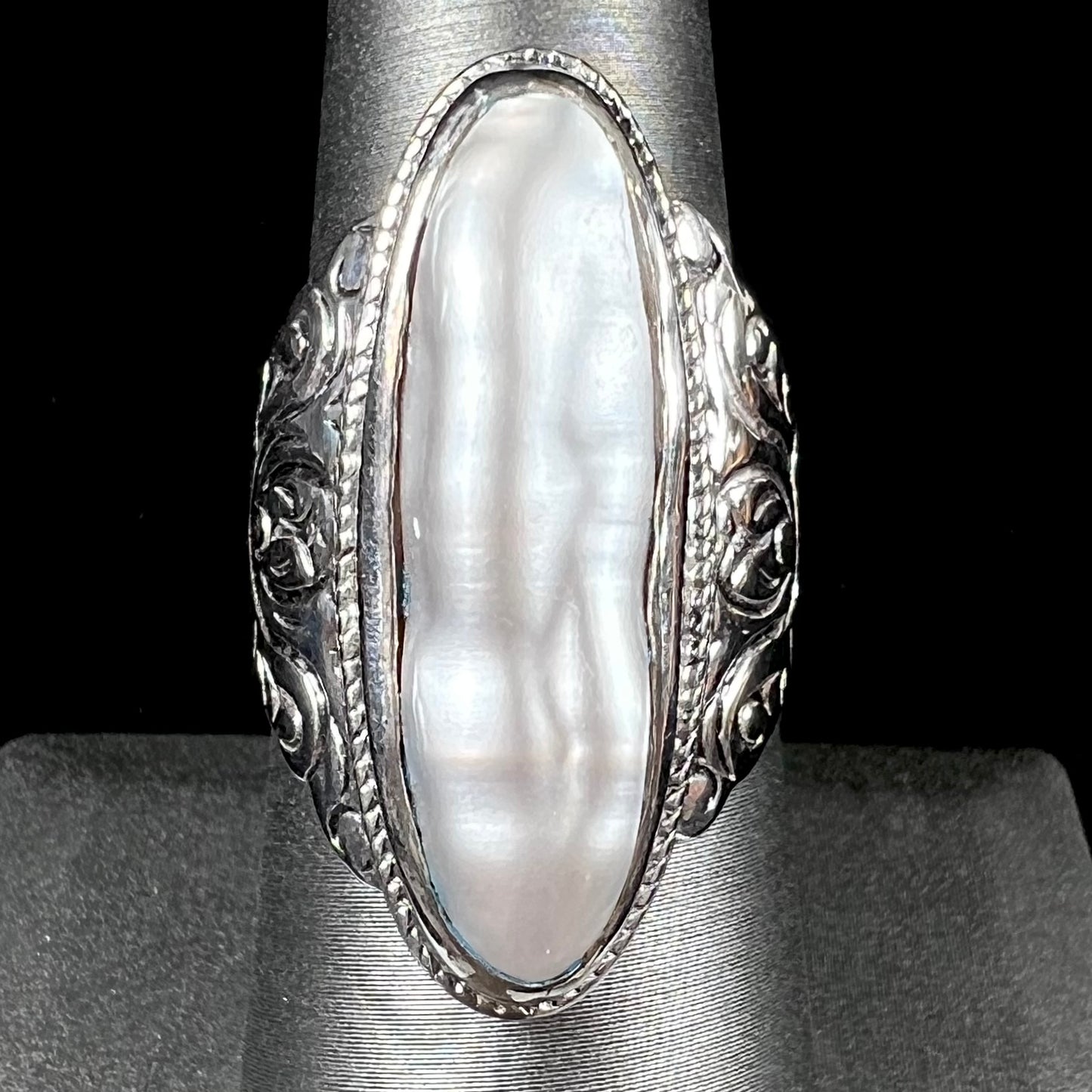 A Boho Chic style sterling silver solitaire ring set with an oval shaped, metallic silver gray mabe pearl.