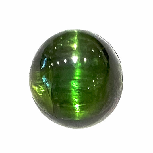 A loose, round cabochon cut green tourmaline stone that displays a cat's eye phenomenon.  The gem weighs 2.93 carats.