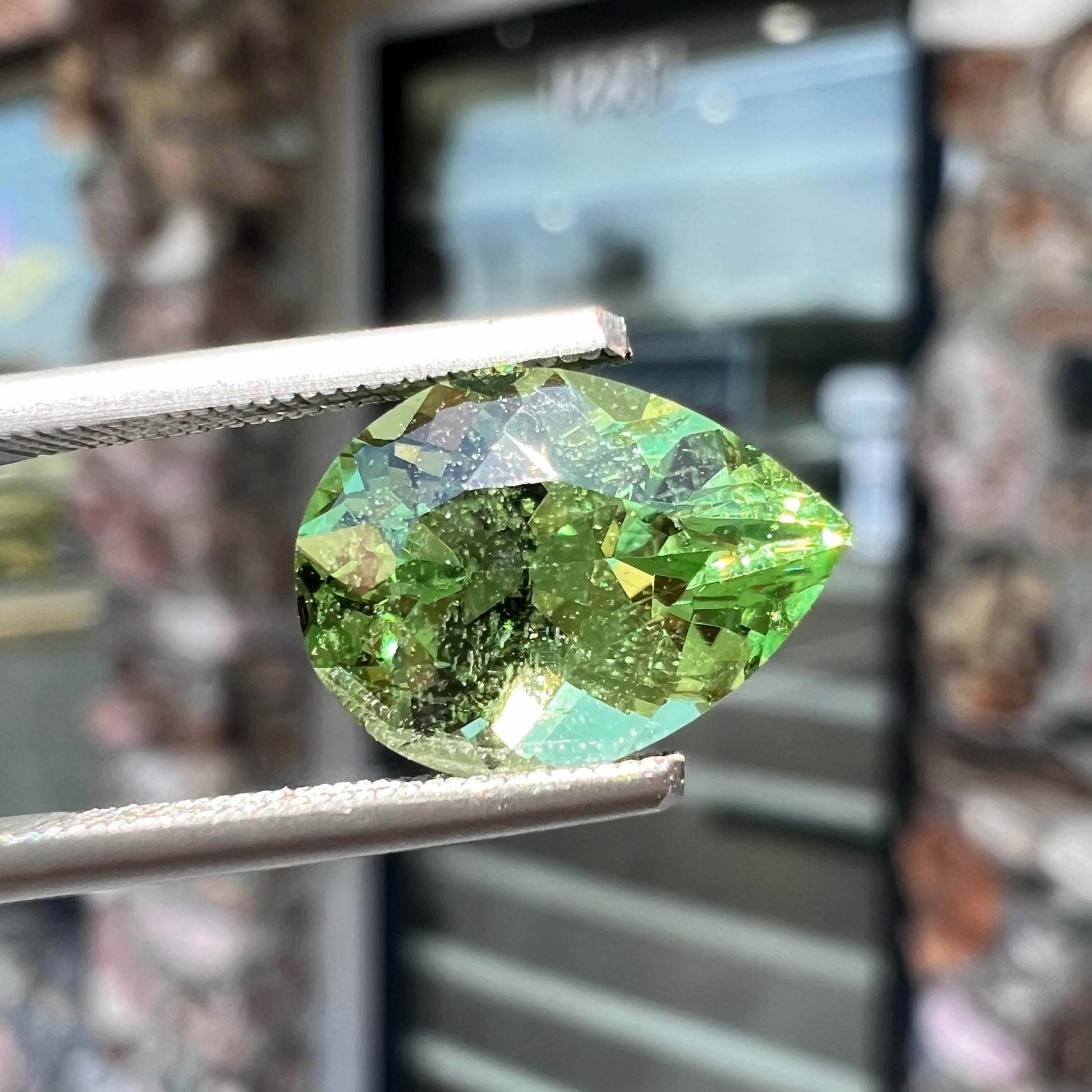 A loose, pear shaped tsavorite garnet gemstone.  The stone is yellowish green.
