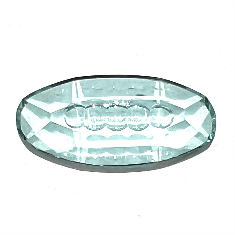 An oval fantasy cut greenish blue aquamarine stone cut by gem carver, Arthur Lee Anderson.