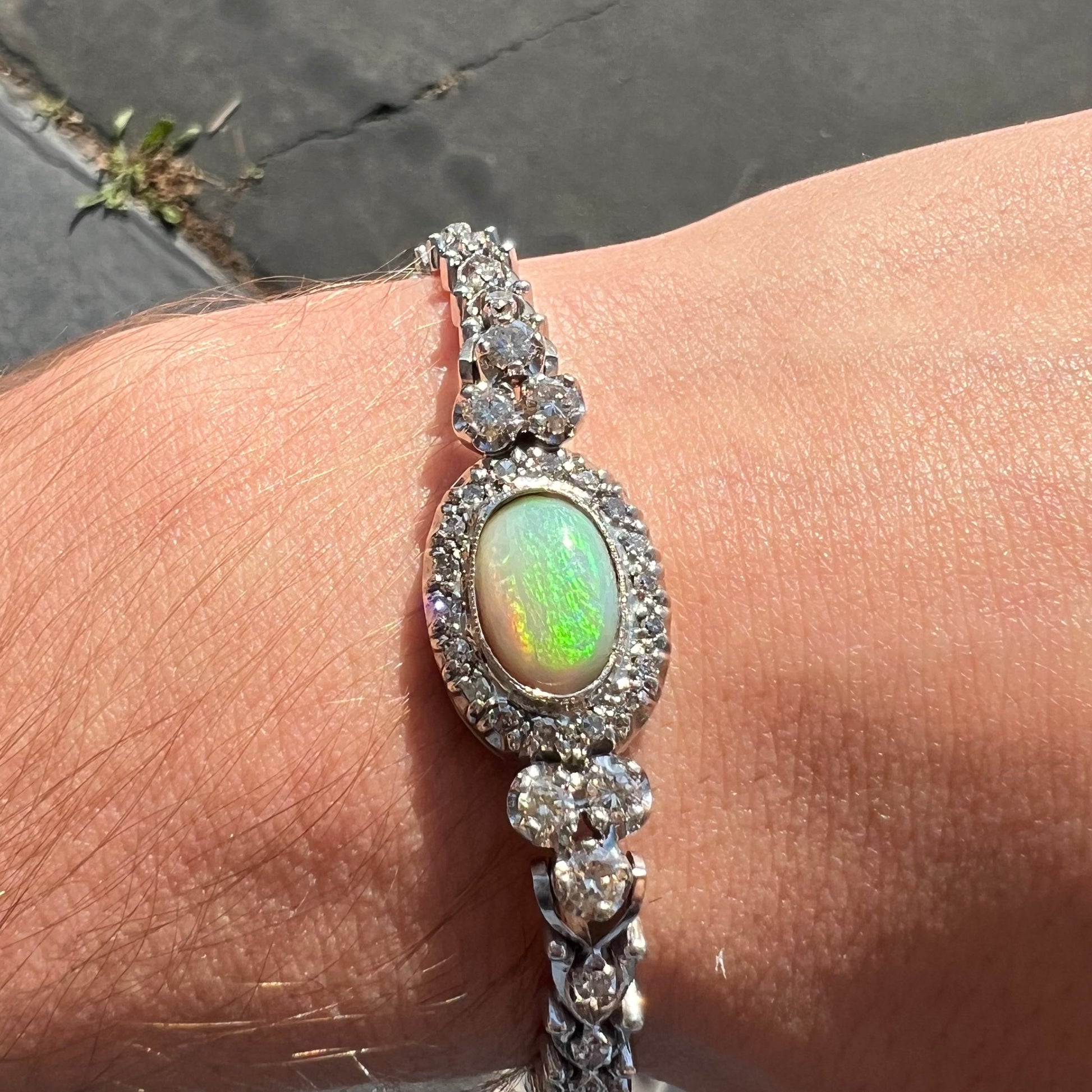 A ladies' vintage, 1930's natural opal bracelet set with accent diamonds in white gold.