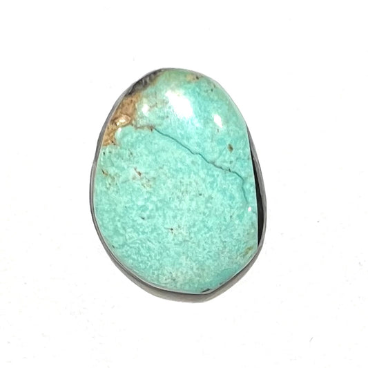 A loose, green Royston turquoise stone from Nevada.  The stone is a freeform cabochon cut.