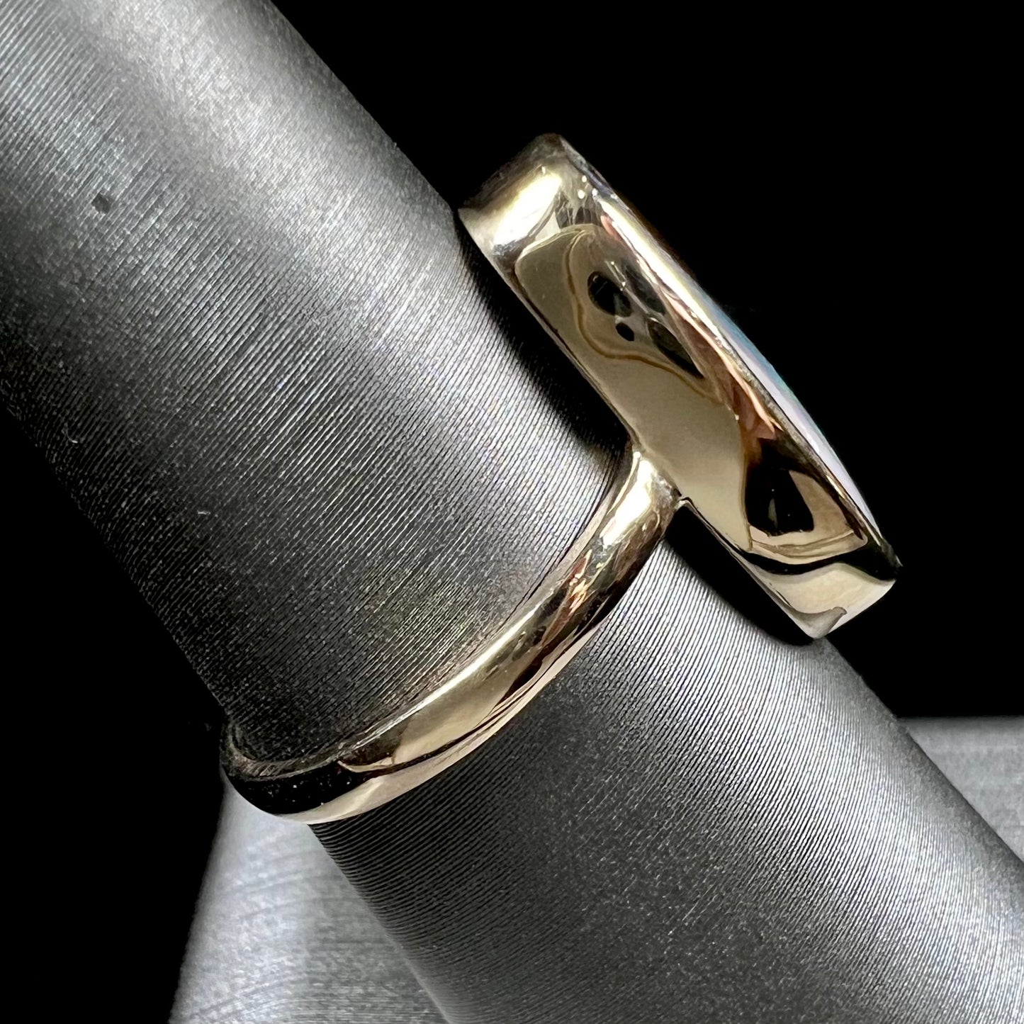Ladies' yellow gold solitaire ring bezel set with a natural green striped boulder opal from Quilpie, Australia.
