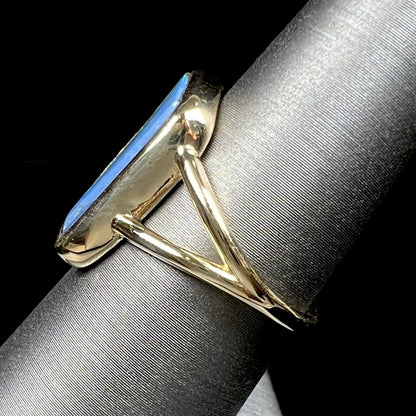 A ladies' split shank gold ring bezel set with a natural, Australian black boulder opal.