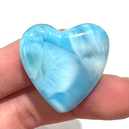 An AAA+ grade larimar stone cut into a heart shaped cabochon.