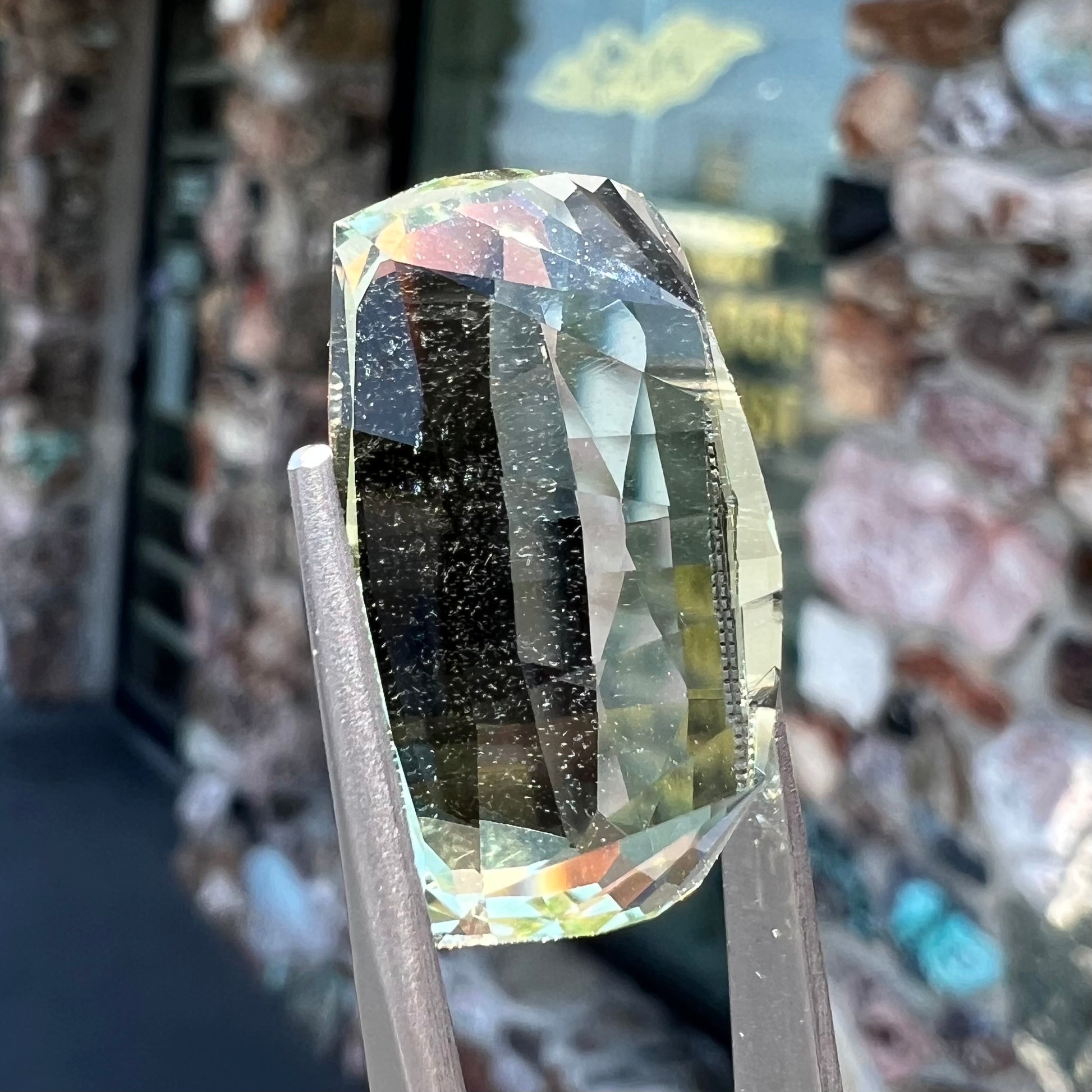A loose, modified cushion cut heliodor beryl gemstone.  The stone is a yellow-green color.