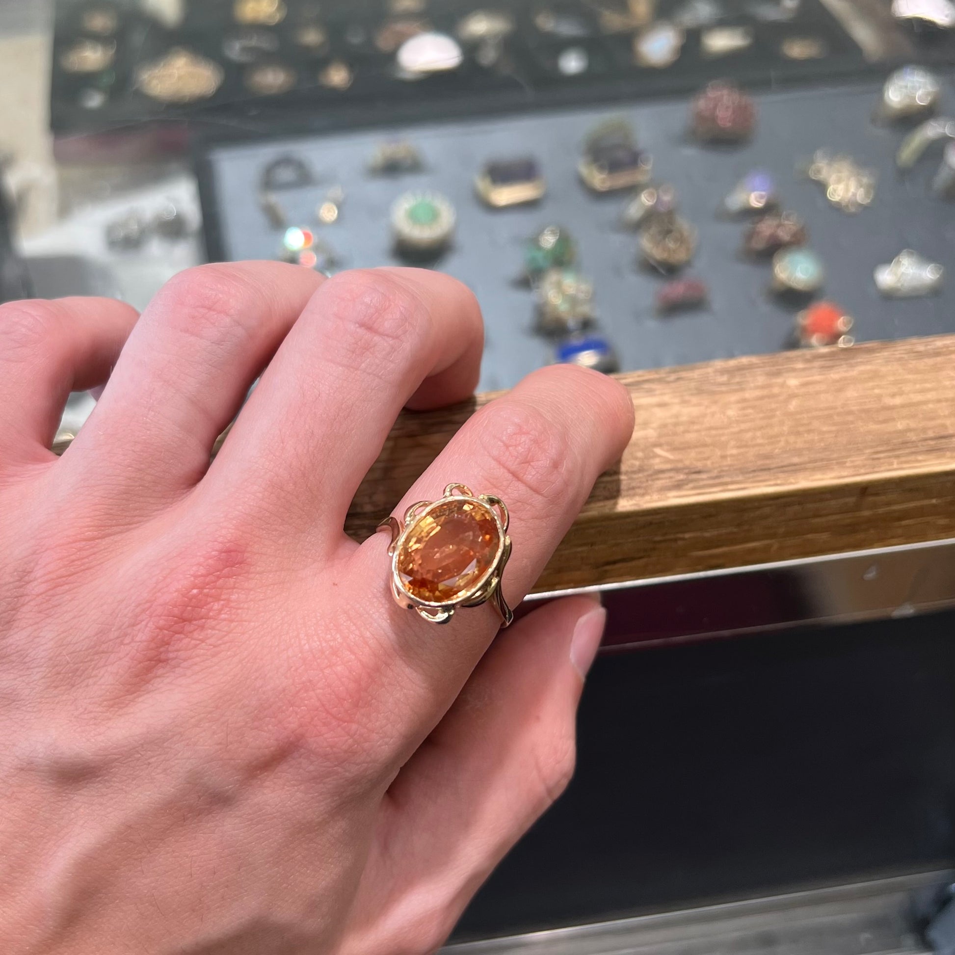 A ladies' yellow gold solitaire ring set with an 8.00 carat oval cut orange hessonite garnet.