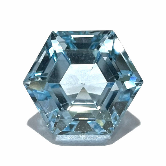 A faceted hexagon cut sky blue topaz gemstone.