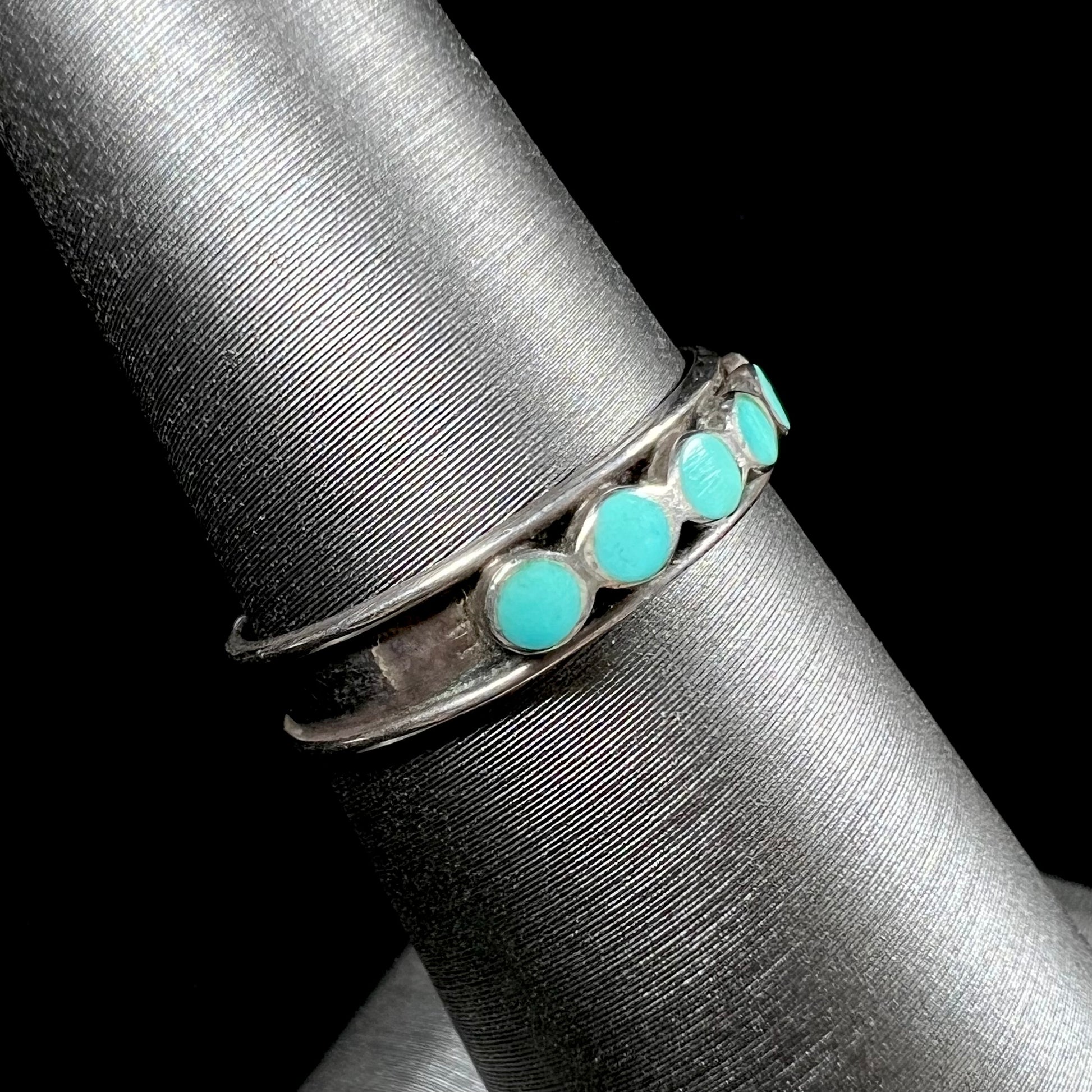 A ladies' sterling silver Hopi style band set with round cut Sleeping Beauty turquoise stones.