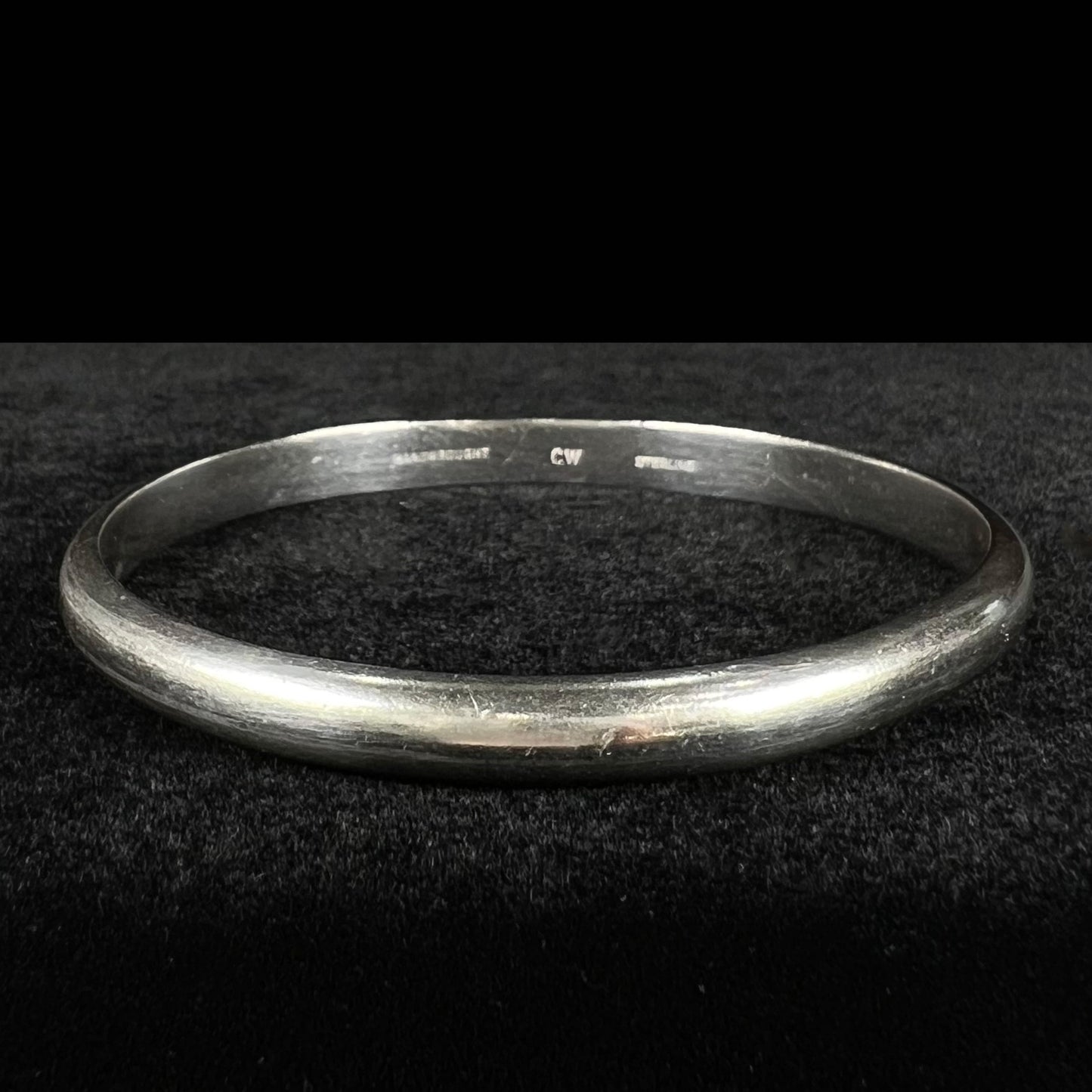 A ladies' sterling silver bangle bracelet stamped "CW" by the Hopi Indian artist, Cheryl Wadsworth.