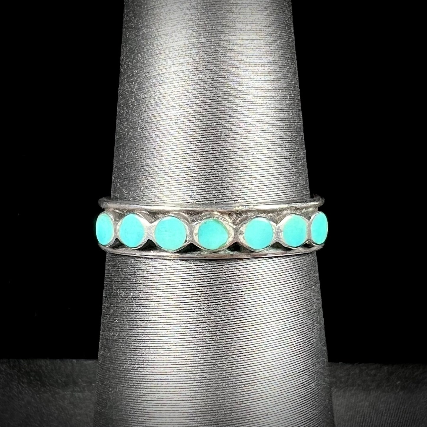 A ladies' sterling silver Hopi style band set with round cut Sleeping Beauty turquoise stones.