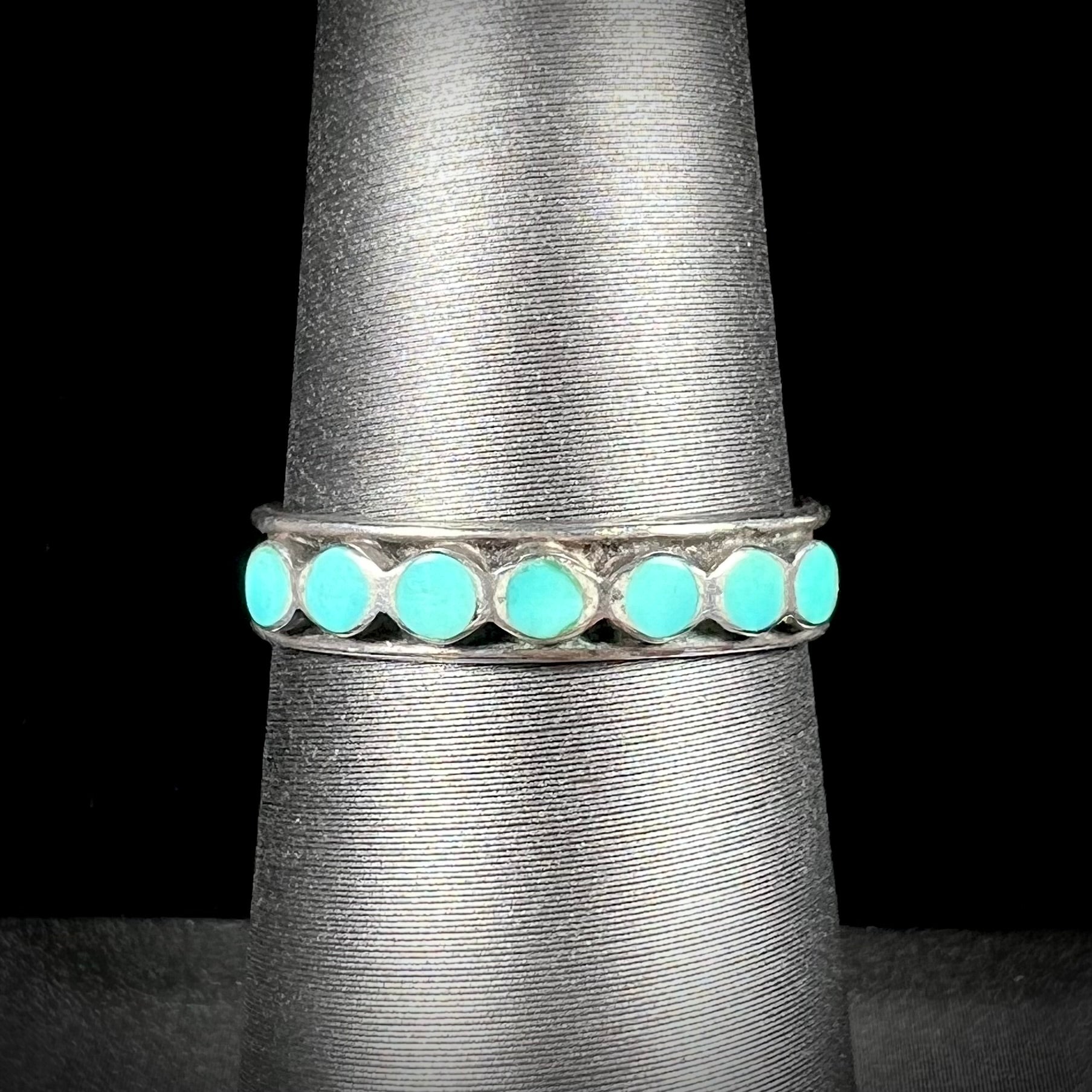 A ladies' sterling silver Hopi style band set with round cut Sleeping Beauty turquoise stones.