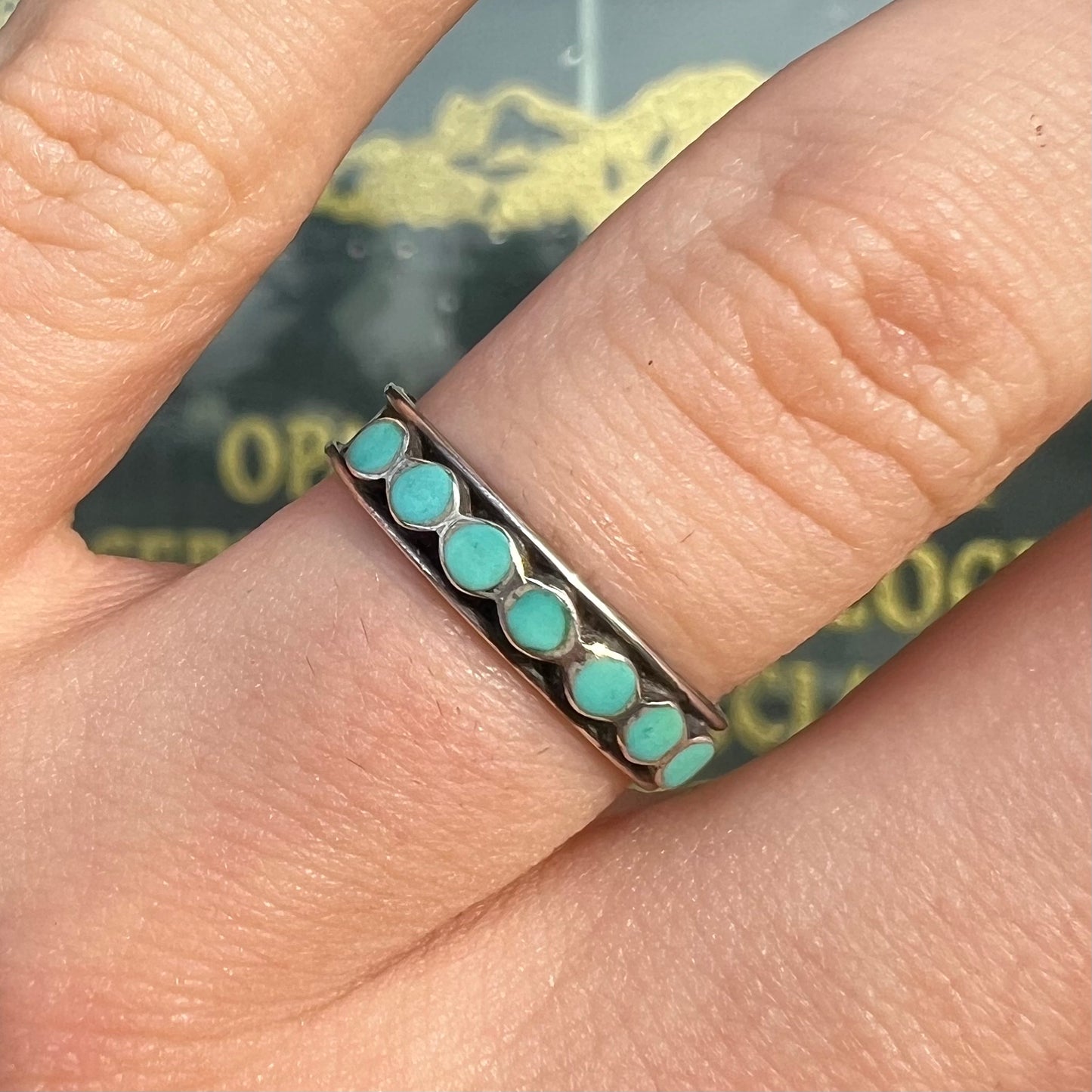 A ladies' sterling silver Hopi style band set with round cut Sleeping Beauty turquoise stones.