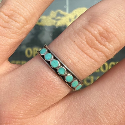 A ladies' sterling silver Hopi style band set with round cut Sleeping Beauty turquoise stones.