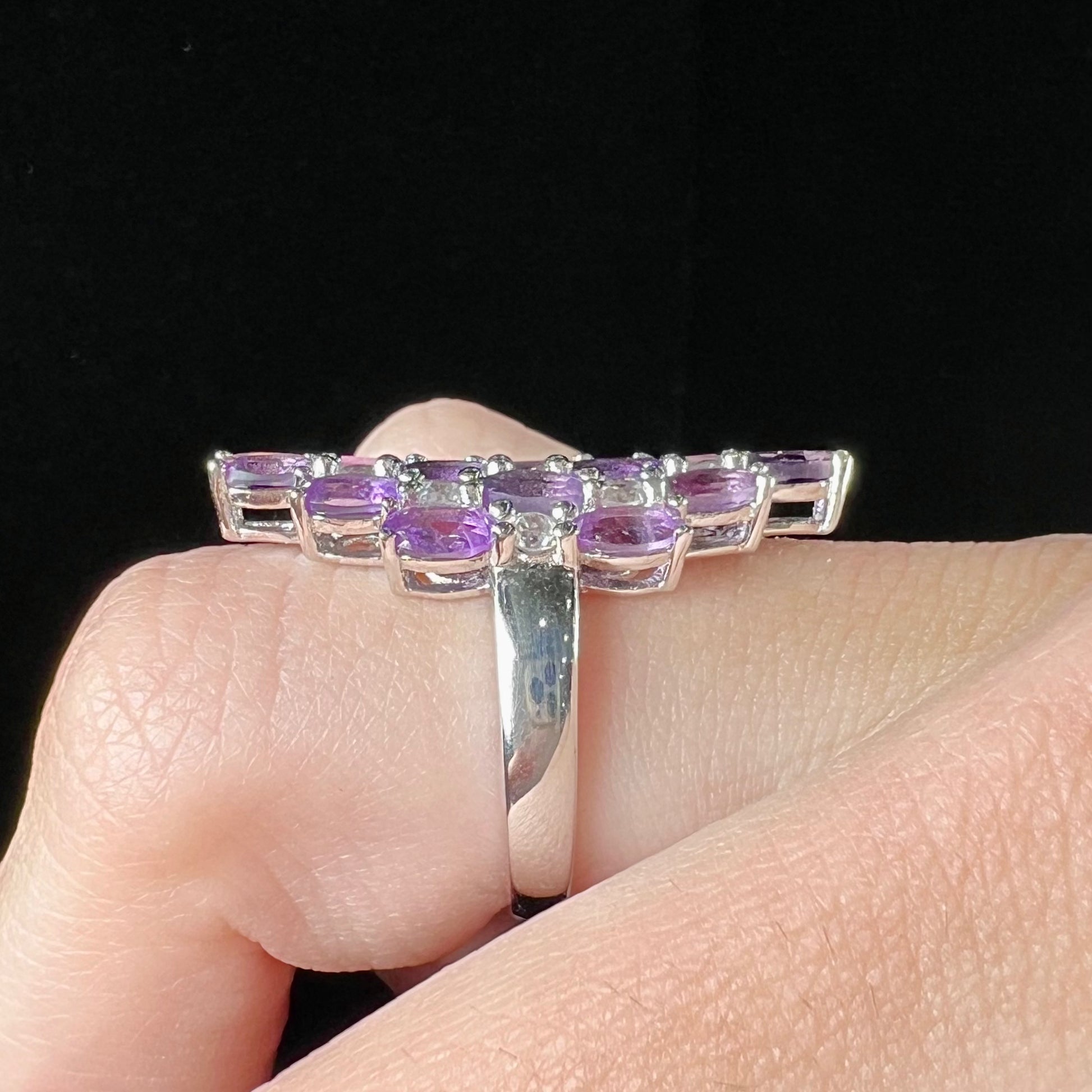 A ladies' modern style sterling silver amethyst and cubic zirconia cluster ring.