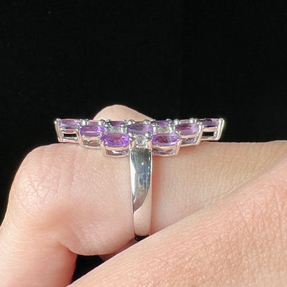 A ladies' modern style sterling silver amethyst and cubic zirconia cluster ring.