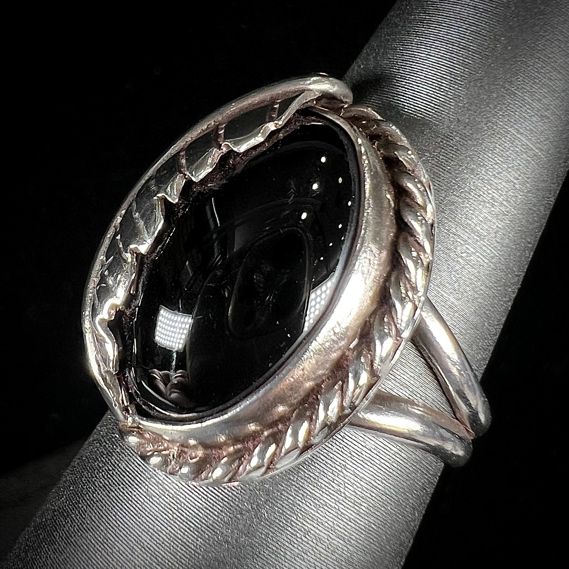 A sterling silver unisex black onyx feather ring.